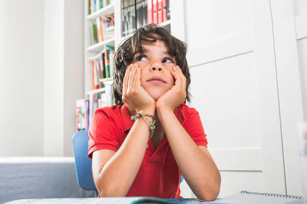 Child showing lack of focus and attention during learning activity indicating ADHD signs