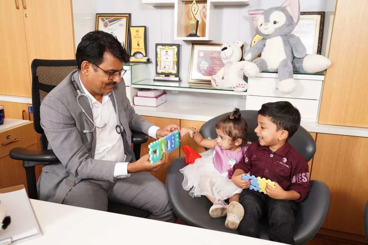 Doctor engaging children in play therapy session to support autism and developmental growth