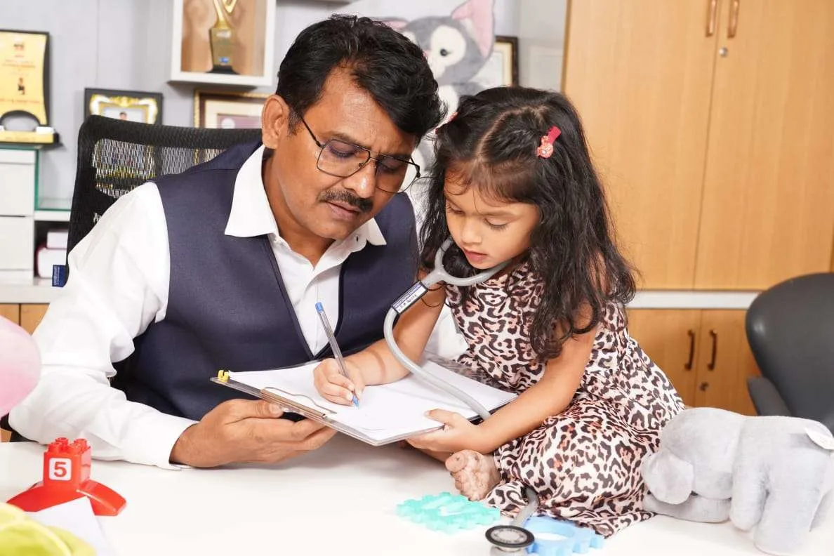 Doctor guiding a child during learning activity to support autism and developmental skills