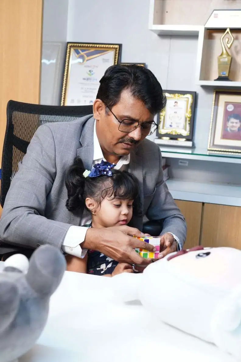 Doctor guiding a child through play therapy to support autism and developmental skills
