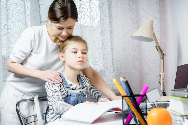 Parent helping child with learning activity to improve focus and developmental skills